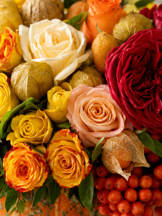 Close-up of pumpkin flower arrangement with roses, physalis, rowan berries, and autumn foliage | Zelena Flora | Los Angeles