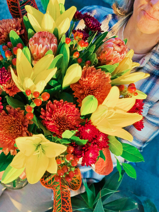 Bouquet of colorful flowers with a person in the background