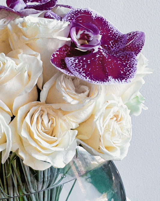 Orchid Elegance luxury glass vase arrangement with ivory roses and purple orchids by Zelena Flora