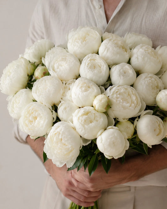 The White Peonies bouquet with fluffy white peony blooms, fresh green leaves, and natural stems by Zelena Flora