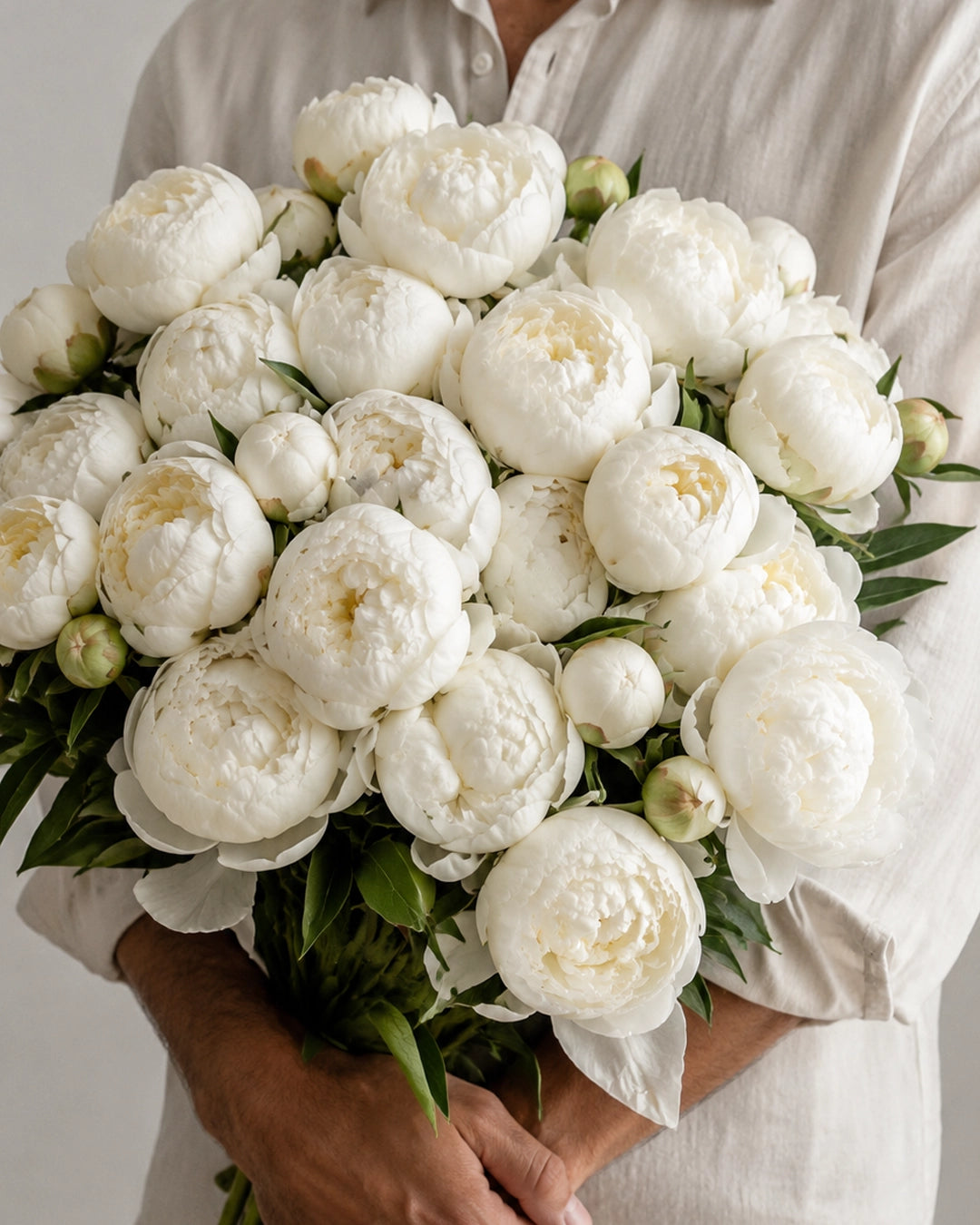 The White Peonies bouquet with fluffy white peony blooms, fresh green leaves, and natural stems by Zelena Flora