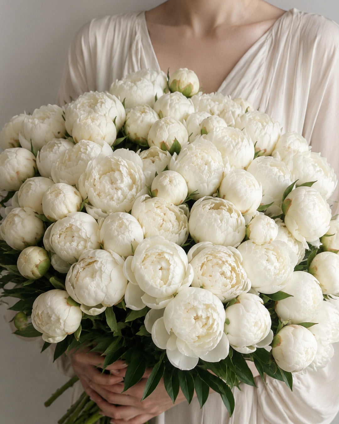 The White Peonies bouquet with fluffy white peony blooms, fresh green leaves, and natural stems by Zelena Flora