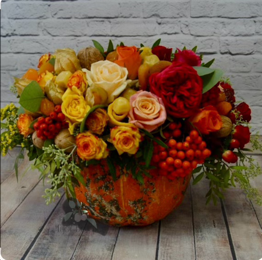 Composition of flowers in a pumpkin