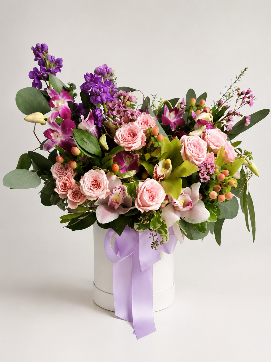 First Date floral box arrangement with blush pink roses, orchids, purple stock flowers, eucalyptus, hypericum berries, and lavender ribbon | Zelena Flora | Los Angeles