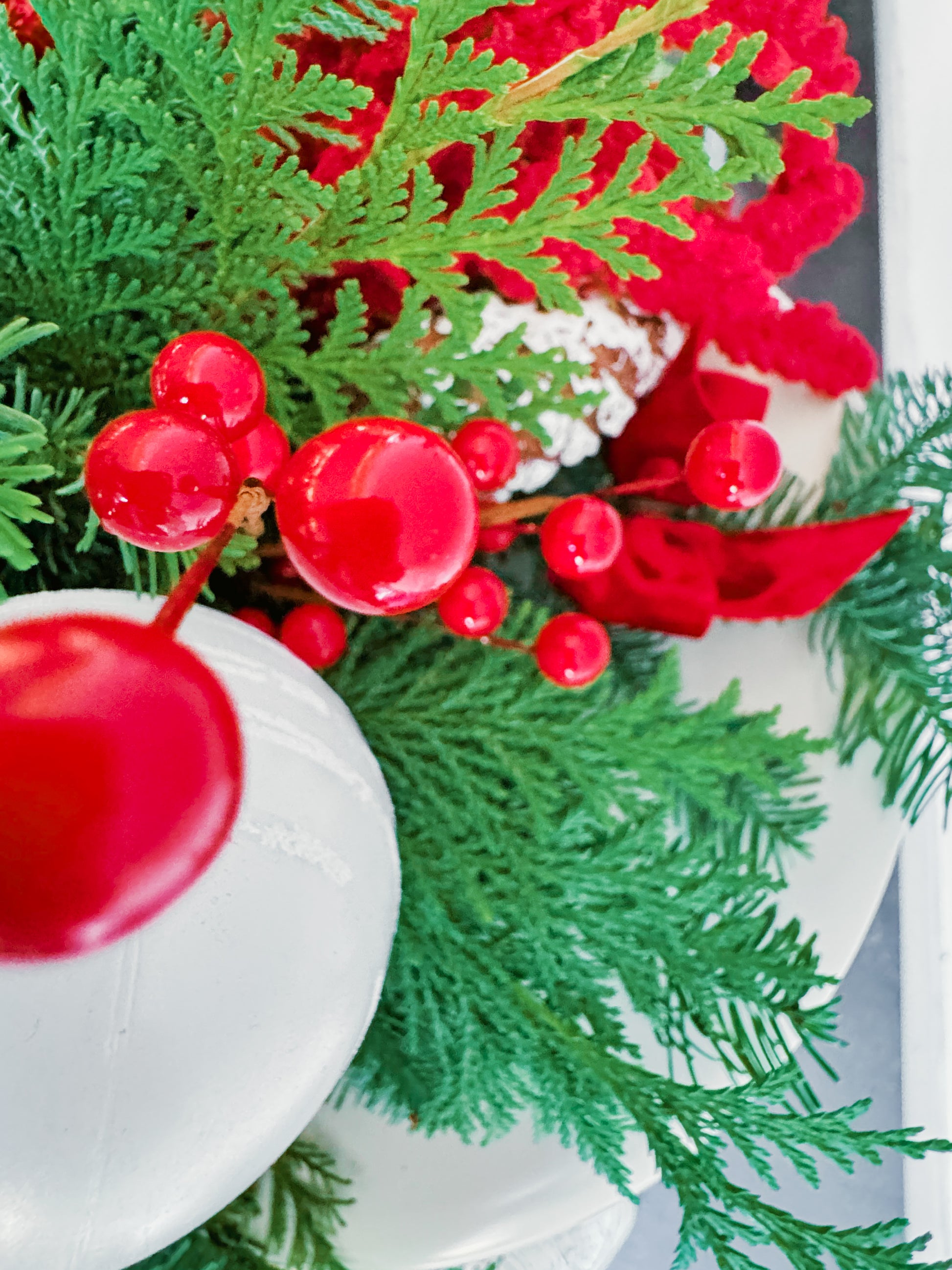 Close-up of a Christmas wreath with red berries and green leaves.