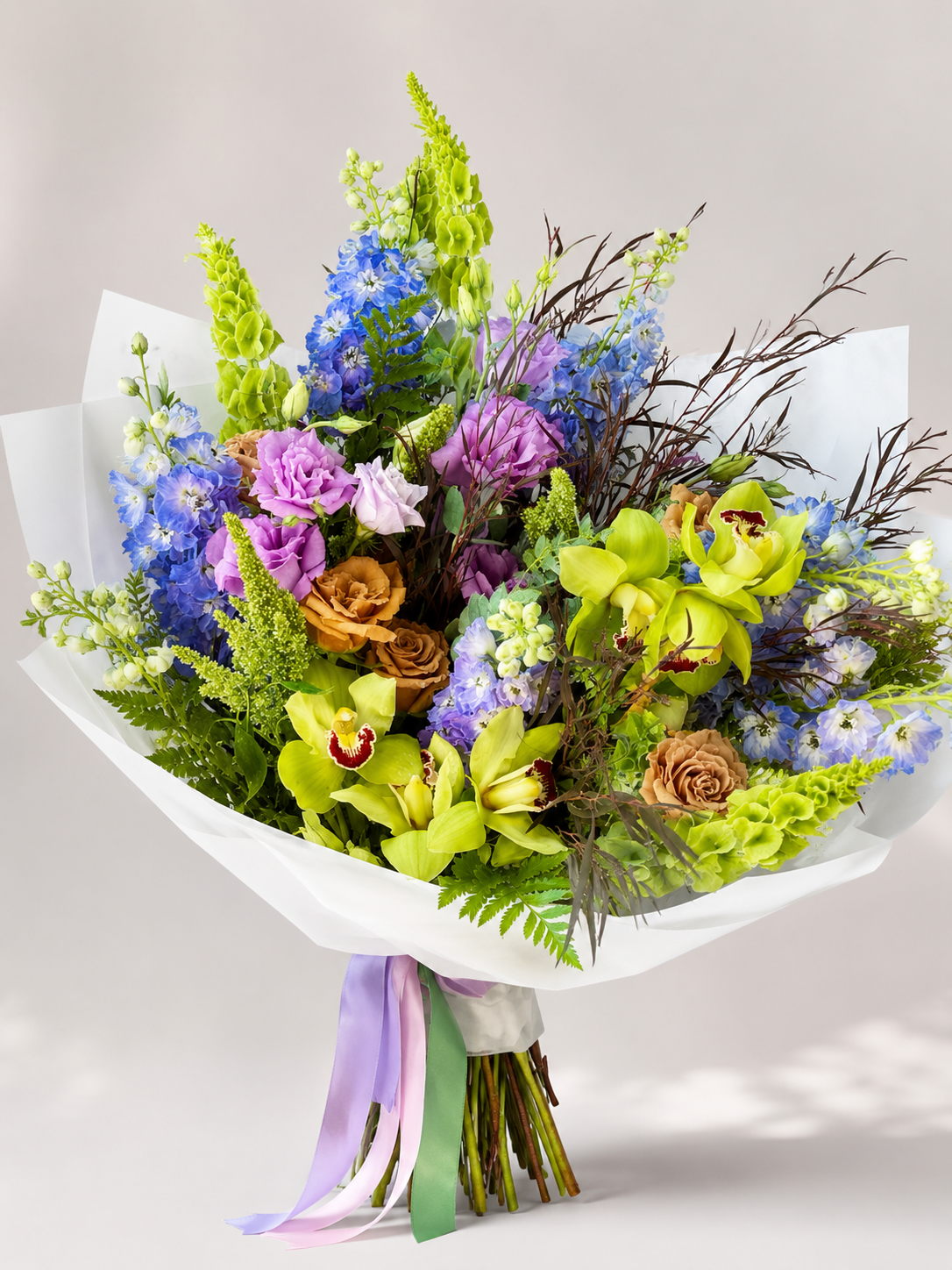 Spring Freshness orchid bouquet with green cymbidium orchids, blue delphinium, lisianthus, Bells of Ireland, roses, stock flowers, and greenery | Zelena Flora | Los Angeles
