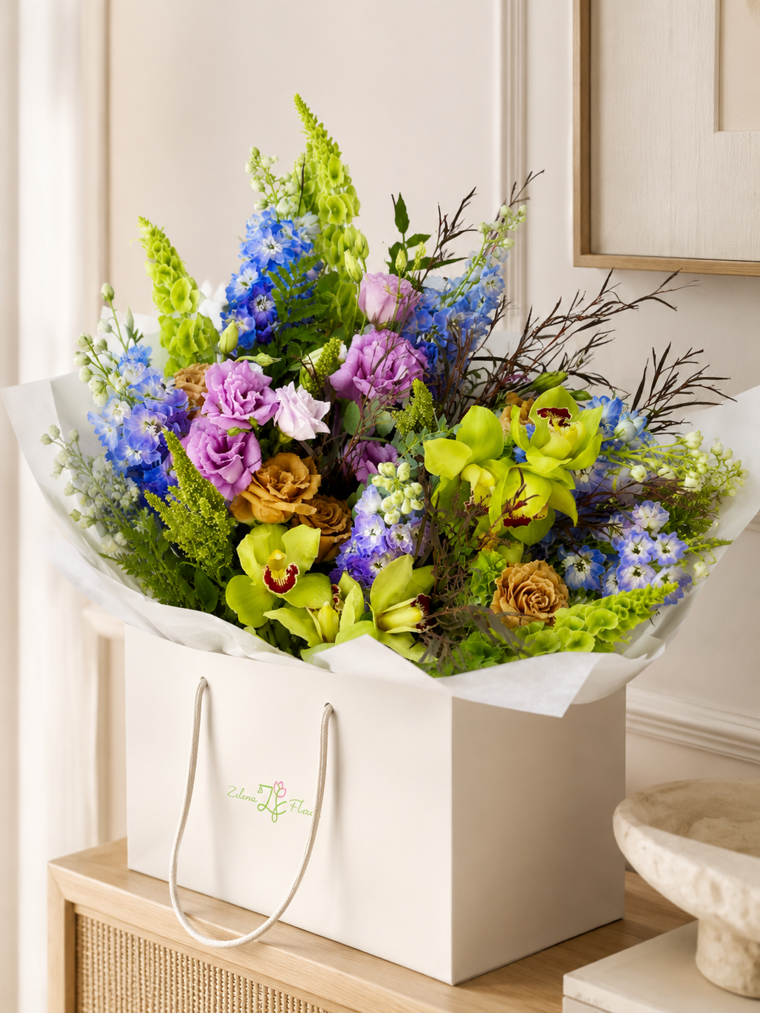 Spring Freshness bouquet with green orchids, blue delphinium, lisianthus, roses, Bells of Ireland, and greenery in a Zelena Flora flower delivery bag | Zelena Flora | Los Angeles