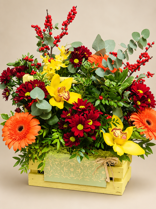 Crown of Fire autumn flower basket with yellow cymbidium orchids, burgundy chrysanthemums, orange gerberas and red berries on a light beige background