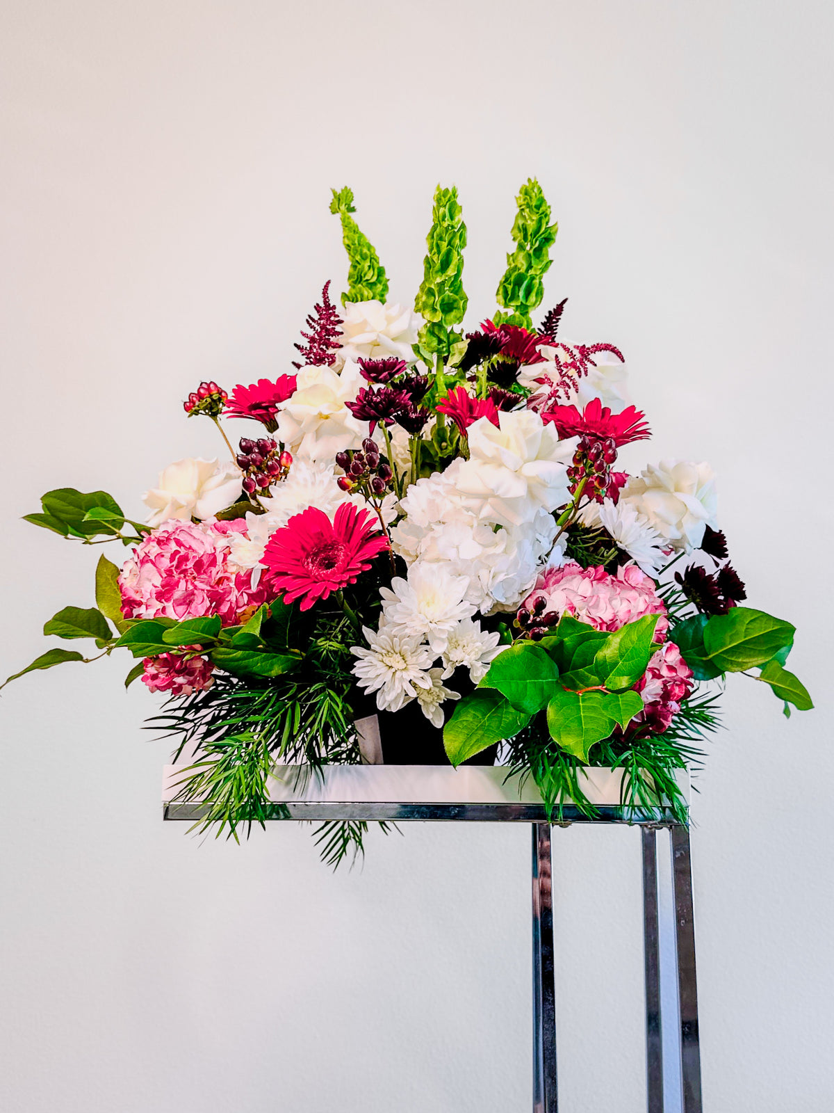 Wide view of Floral Fanfare with an upright red, white and pink floral silhouette on a separate display stand.