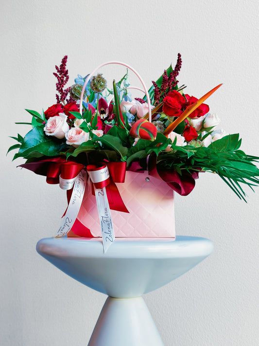 Full view of Rosy Runway handbag flower arrangement by Zelena Flora