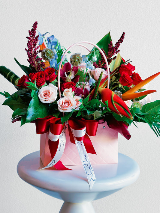 Rosy Runway floral arrangement in a pink handbag by Zelena Flora